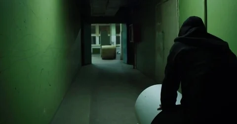 Horror. A man rolls out a large roll of paper Stock Footage 79956987