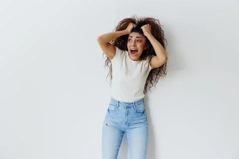 HORROR PANIC ATTACK CONCEPT. Crazy beautiful Latin female with afro rips out Stock Photos