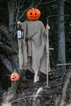Horror pumpkin with a scythe Stock Photos