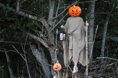 Horror pumpkin with a scythe Stock Photos