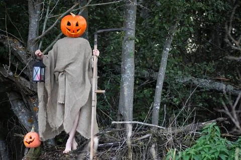 Horror pumpkin with a scythe Stock Photos