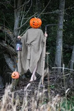 Horror pumpkin with a scythe Stock Photos
