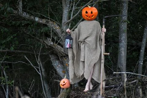 Horror pumpkin with a scythe 写真素材