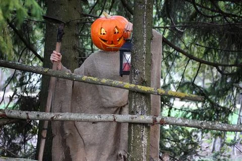 Horror pumpkin with a scythe 写真素材