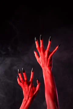 Horror red devil hands with black nails 스톡 사진
