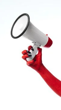 Horror red devil's hand with blank long nails holding megaphone against white Stock Photos