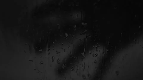 Horror scary rain on a window with a dark man's hand during halloween night. Stockbeeldmateriaal 209181390