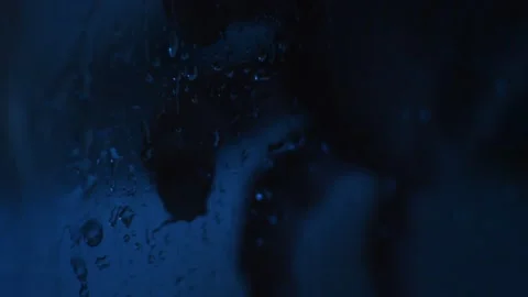 Horror scary rain on a window with a dark man's hand during halloween night. Stockbeeldmateriaal 209181403