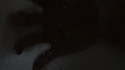 Horror scary rain on a window with a dark man's hand during halloween night. Stockbeeldmateriaal 209181467