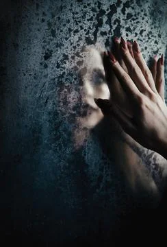 Horror scene: blurry reflection of the ghost girl in old dirty mirror Stockfoto's