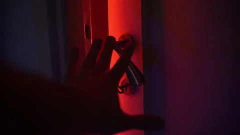 Horror scene with hand of murderer opening slowly door into the room with bright Vídeos de archivo 165113719