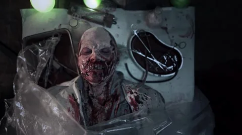 Horror scene of a lying dead zombie - scientist on the table Stock Footage 68850956