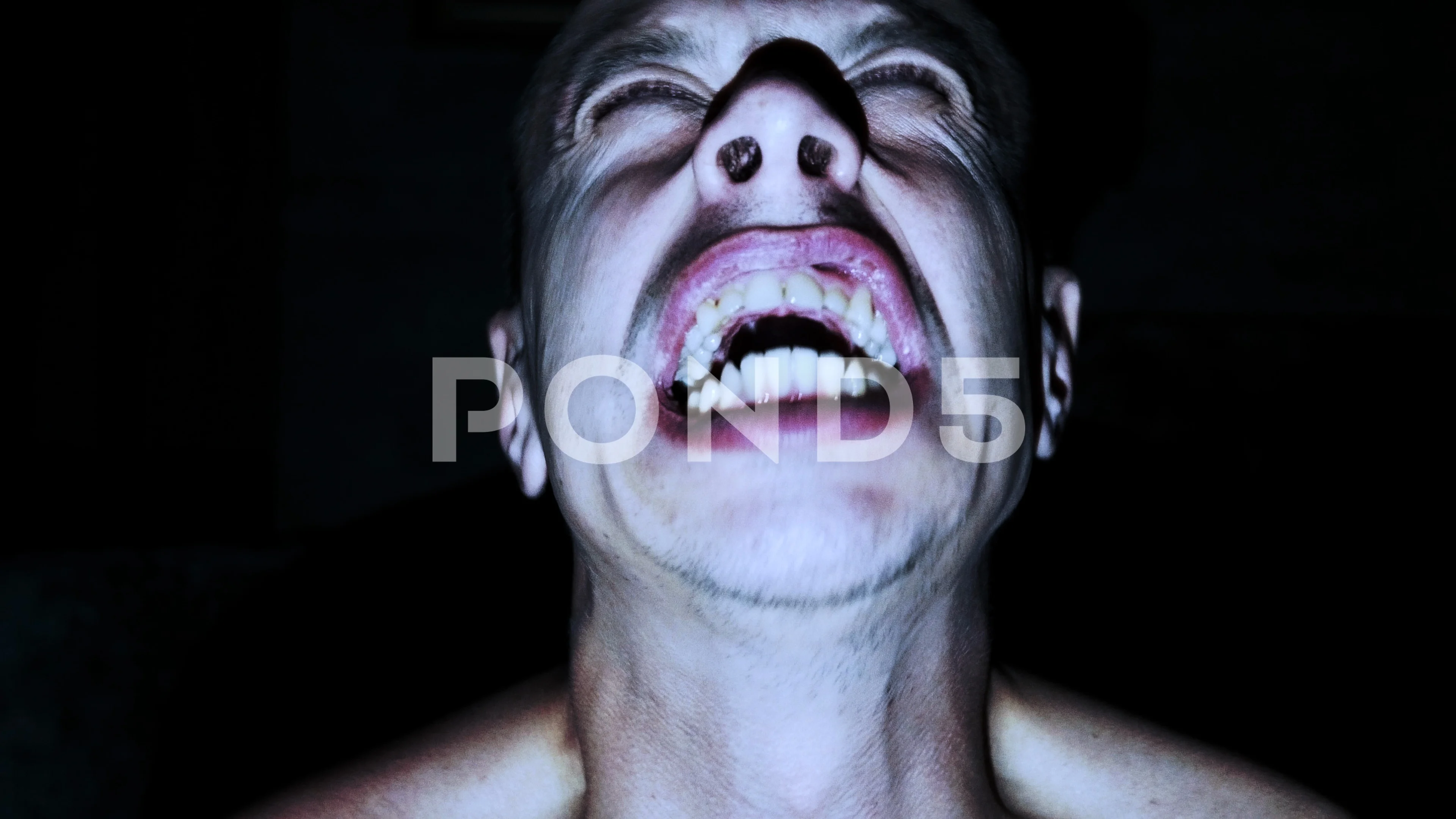 Horror Scene With Screaming Scary Human Face With A Harsh Light On A Black  - Halloween Concept With Young Man With Open Mouth And Teeth Stock Photo,  Picture and Royalty Free Image.