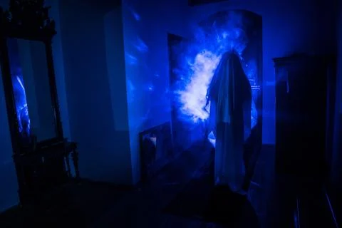 Horror silhouette of ghost inside dark room with mirror Scary halloween conce Stock Photos