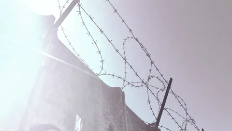 Horror view of hight concrete wall with barbwire separating criminals from 스톡 동영상 302990380