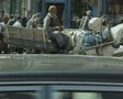 Horse and cart moving through town SD Footage