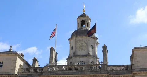 Horse Guards clock tower with Union Jack under blue London sky Stock Footage 321018848