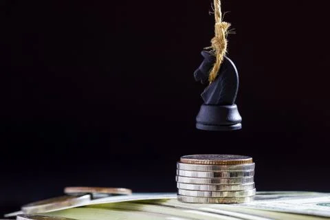 Horse or king of chess execute by hanging on dollar banknote and coin. Stock Photos