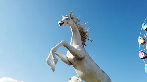 Horse statue on the sky with clouds Stock Photos