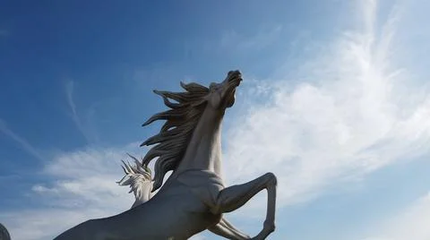 Horse statue on the sky with clouds Stock Photos