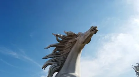 Horse statue on the sky with clouds Stock Photos