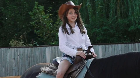 Horse trainer works with a girl on the arena in a sunny day. Slowly Stock Footage