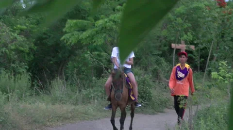 Horseback riding down a remote Philippine road Video stock 52043924