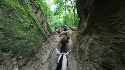 Horseback Riding Through Deep Narrow Earth Trench Stock Footage 342571029