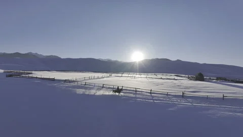 Horseman riding fast through deep snow at sunrise in Kazakhstan Stock Footage 320774453