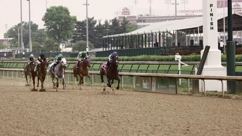 Horses racing in the Kentucky Derby at Churchill Downs in slow motion Stock Footage