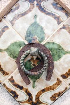 Horseshoe on a wall tile Stock Photos