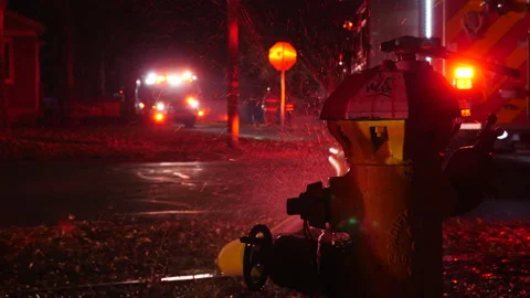 Hose connected to fire hydrant at house fire. Stock Footage 259744250