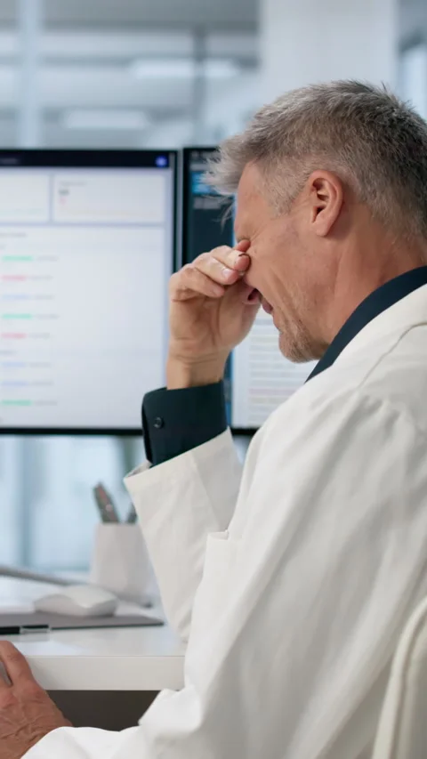 Hospital Administrator Looks Stressed While Reviewing Spreadsheets Stock Footage 336368343