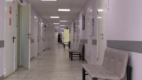 Hospital corridor with cabinets, wards, doors and walk work medical staff Stock Footage 82751953