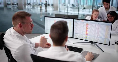 Hospital Doctors Analyzing Billing Codes Online, Diverse Medical Team Collabo Stock Photos