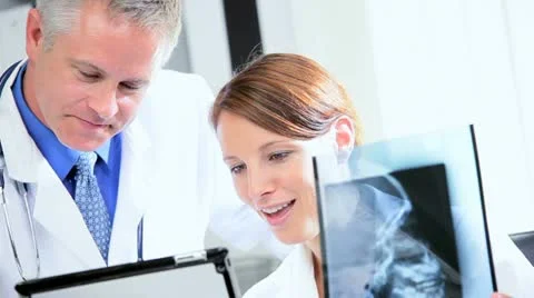 Hospital Doctors Using X-Ray with Wireless Tablet Stock Footage 11369691