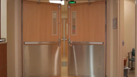 Hospital double doors opening in hallway Stock Footage