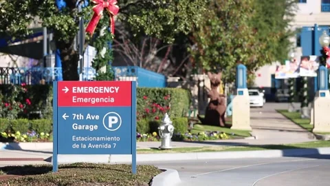 Hospital Emergency Room sign exterior b roll of building from parking lot Stock Footage