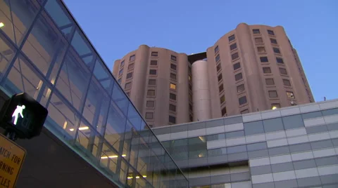 Hospital exterior pan down to entrance Stock Footage