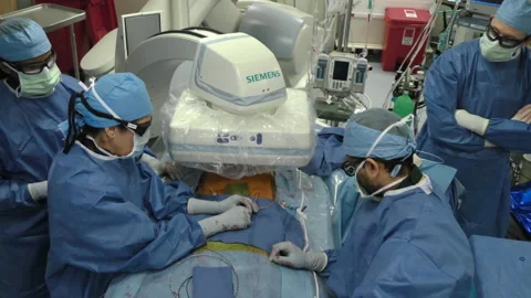 Hospital OR surgeons insert laparoscopic cable Stock Footage 147096110