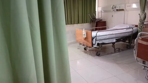 Hospital ward featuring an empty bed with medical equipment. Stock Footage 303867485