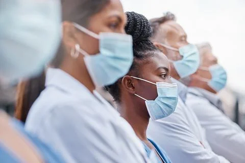Hospital workers are heroes. Closeup shot of a group of doctors wearing masks. Stock Photos