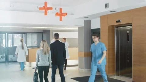 In the Hospital Young Couple Walks to Reception. Medical Personnel, Doctors Stock Footage