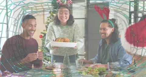 Host carrying roast toward table, guests passing salad and rolls, sharing Stock Footage 319567563