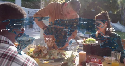 Host carving turkey sharing meal initiating animated tech map overlay while Stock Footage 316959869