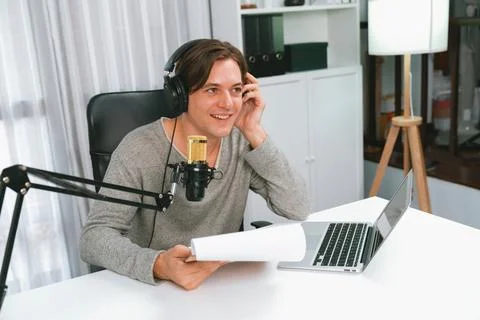 Host channel in broadcaster with script note reading to listeners. Pecuniary. Stock Photos