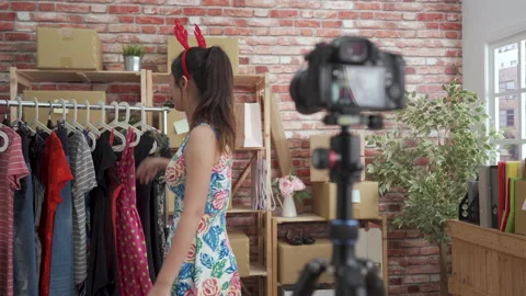 Host introducing beautiful party dress selling Stock Footage 147624082
