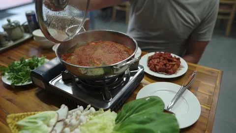 Host Prepares Spicy Stew. Cooking Hotpot With Fresh Vegetables. Home Chef Stockbeeldmateriaal 332686526