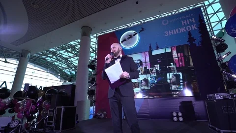 Host Of The Show Standing On A Brightly Lit Stage, Slow Motion Video stock 103056233