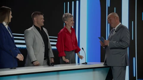 Host talking to contestants during recording of a fictional morning game show Stock Footage 246590807